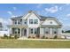 Charming two-story home featuring gray siding, dark shutters, and manicured landscaping at 45 Pond Mountain Dr, Clayton, NC 27520