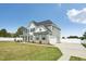 Exterior view of a two-story home featuring gray siding, a driveway, and a well-kept lawn at 45 Pond Mountain Dr, Clayton, NC 27520