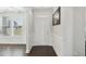 Bright foyer featuring beautiful wainscoting, hardwood floors, a window and a white front door at 45 Pond Mountain Dr, Clayton, NC 27520
