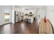 Open kitchen with stainless steel appliances, a granite island, and dark wood flooring at 45 Pond Mountain Dr, Clayton, NC 27520