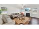 Cozy living room featuring a fireplace, large windows, hardwood floors and comfortable furniture at 45 Pond Mountain Dr, Clayton, NC 27520