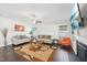 Bright living room with a fireplace, hardwood floors, comfortable seating and ceiling fan at 45 Pond Mountain Dr, Clayton, NC 27520
