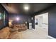 Finished media room with theater lighting, comfortable seating, and space for entertaining at 45 Pond Mountain Dr, Clayton, NC 27520