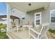 Covered patio with outdoor seating, offering a relaxing space with views of the backyard at 45 Pond Mountain Dr, Clayton, NC 27520