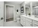 Well-lit bathroom with dual sink vanity, framed mirror, walk-in closet, and a clean, modern aesthetic at 460 Grand Silo Rd, Garner, NC 27603