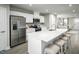 Bright kitchen featuring a white color palette, stainless appliances, herringbone backsplash, and counter seating at 460 Grand Silo Rd, Garner, NC 27603