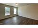 Spacious bedroom with hardwood floors, two windows, and ample natural light at 480 Traditions Grande Blvd # 31, Wake Forest, NC 27587