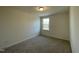 This carpeted bedroom offers a bright window view to the outdoors at 480 Traditions Grande Blvd # 31, Wake Forest, NC 27587