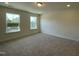 A carpeted bedroom with two windows for plenty of natural light at 480 Traditions Grande Blvd # 31, Wake Forest, NC 27587
