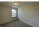 A bright bedroom offers wall-to-wall carpet and a window view to the outdoors at 480 Traditions Grande Blvd # 31, Wake Forest, NC 27587