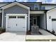 Charming townhome exterior with a one-car garage, neutral siding, and manicured landscaping at 480 Traditions Grande Blvd # 31, Wake Forest, NC 27587