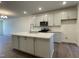 Open kitchen with a large island, quartz countertops, and stainless steel appliances at 480 Traditions Grande Blvd # 31, Wake Forest, NC 27587