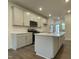 Modern kitchen with a center island, ample counter space, and stainless steel appliances at 480 Traditions Grande Blvd # 31, Wake Forest, NC 27587