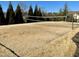 Community sand volleyball court bordered by evergreens; an outdoor recreational amenity at 480 Traditions Grande Blvd # 31, Wake Forest, NC 27587