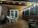 Inviting back porch with string lights and rocking chairs at 5520 Mccormick Rd, Durham, NC 27713