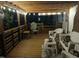 Well-lit wooden back porch featuring comfortable seating at 5520 Mccormick Rd, Durham, NC 27713