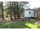 Lush backyard with fire pit, mature trees, and landscaping at 5520 Mccormick Rd, Durham, NC 27713