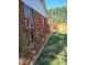 Charming backyard features a brick exterior, blossoming trees, and a well-maintained lawn at 5520 Mccormick Rd, Durham, NC 27713