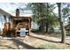 Home's backyard featuring mature trees, a stainless steel BBQ and a deck at 5520 Mccormick Rd, Durham, NC 27713