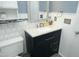 Well-lit bathroom featuring a vanity with a sink, mirror, and tiled backsplash at 5520 Mccormick Rd, Durham, NC 27713