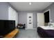 The bedroom features gray carpet, a TV, shelving, and a door with a hanging scroll at 5520 Mccormick Rd, Durham, NC 27713
