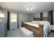 This bedroom boasts a decorative bed, neutral walls, and natural light from the window at 5520 Mccormick Rd, Durham, NC 27713