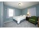 Bedroom with a chair, window, and soft blue walls creating a peaceful retreat at 5520 Mccormick Rd, Durham, NC 27713