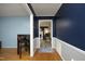 View of the dining area with wood floors and chair rail walls at 5520 Mccormick Rd, Durham, NC 27713