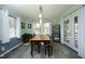 Bright dining room with natural light, wood table, and access to outdoor area at 5520 Mccormick Rd, Durham, NC 27713