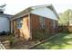 Brick home exterior with lush landscaping and flower bushes at 5520 Mccormick Rd, Durham, NC 27713
