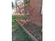 Home's exterior featuring landscaped yard with vibrant pink flowers at 5520 Mccormick Rd, Durham, NC 27713