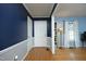 View of the foyer with wood floors, blue walls, and stained glass at 5520 Mccormick Rd, Durham, NC 27713