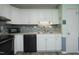 Well-lit kitchen with white cabinets, modern backsplash, and stainless steel appliances at 5520 Mccormick Rd, Durham, NC 27713