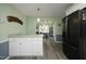 Kitchen with black refrigerator, view to dining area, and lots of natural light at 5520 Mccormick Rd, Durham, NC 27713