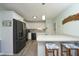 Modern kitchen with stainless steel appliances, white cabinets, and breakfast bar at 5520 Mccormick Rd, Durham, NC 27713