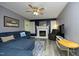 Cozy living room featuring plush blue seating, a decorative fireplace, and a ceiling fan at 5520 Mccormick Rd, Durham, NC 27713