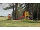 Community playground with colorful equipment, mature trees, and open green space at 5520 Mccormick Rd, Durham, NC 27713
