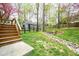 View of the backyard featuring a quaint shed and steps to an elevated deck at 5608 Ventura Dr, Durham, NC 27712