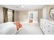Spacious primary bedroom featuring neutral walls, carpet, and a ceiling fan for comfortable living at 5608 Ventura Dr, Durham, NC 27712