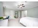 Large bedroom with neutral walls, carpet, ceiling fan, study desk, and ample natural light at 5608 Ventura Dr, Durham, NC 27712