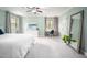 Spacious bedroom with carpet, neutral-toned walls, natural light, ceiling fan, and stylish decor at 5608 Ventura Dr, Durham, NC 27712