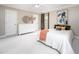 Large bedroom with neutral walls, carpet, ceiling fan, windows, and stylish decor at 5608 Ventura Dr, Durham, NC 27712
