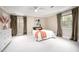 Large bedroom with neutral walls, carpet, ceiling fan, windows, and stylish decor at 5608 Ventura Dr, Durham, NC 27712