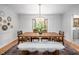 Bright dining room features a modern chandelier and large window, providing an elegant entertaining space at 5608 Ventura Dr, Durham, NC 27712