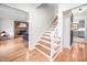Inviting entryway with hardwood floors, staircase, and seamless flow into the living room and kitchen at 5608 Ventura Dr, Durham, NC 27712