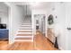Bright foyer featuring hardwood floors, a staircase, and stylish decor at 5608 Ventura Dr, Durham, NC 27712
