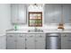 Gray kitchen with stainless steel appliances, granite counters, and a window with a view at 5608 Ventura Dr, Durham, NC 27712