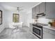 Eat-in kitchen with stainless steel appliances, gray cabinets, and bright breakfast nook at 5608 Ventura Dr, Durham, NC 27712
