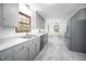Open kitchen with updated appliances, gray cabinets, and an adjacent dining area at 5608 Ventura Dr, Durham, NC 27712