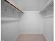 Walk-in closet providing substantial storage space with ample shelving and carpeted flooring at 5608 Ventura Dr, Durham, NC 27712